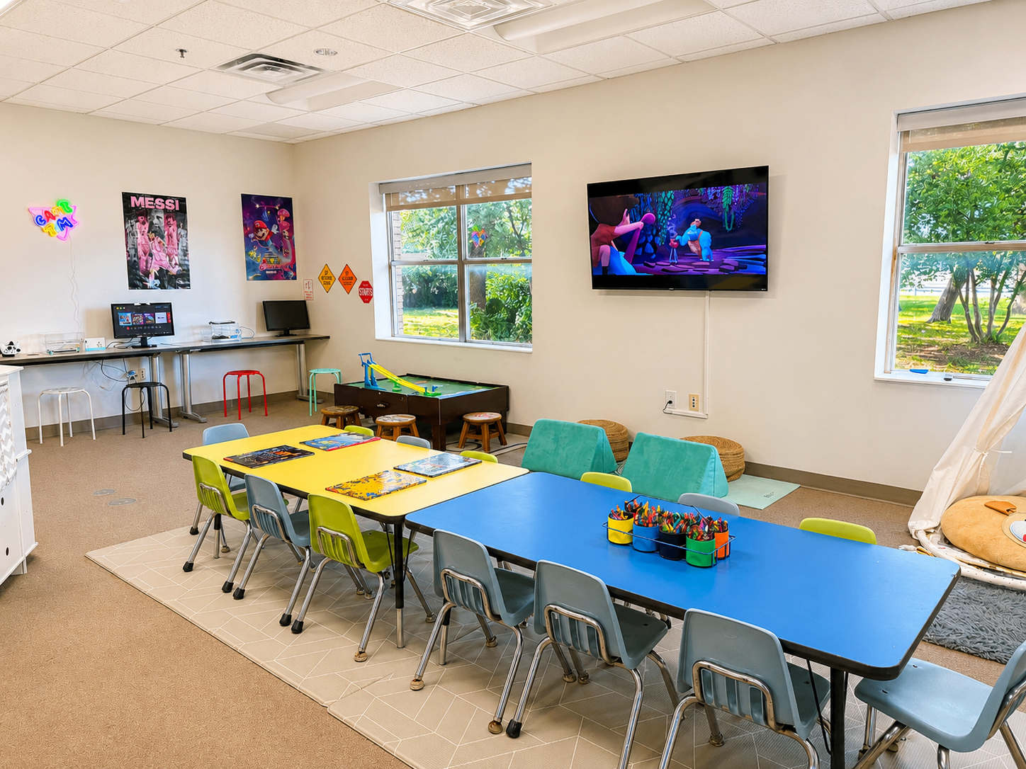 School-age room with game station, TV, and activity tables